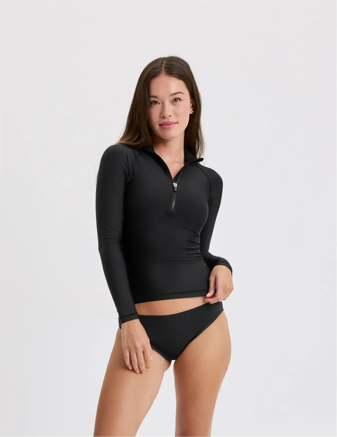 Front view of model wearing the Teen Sunny Skies Rash Guard highlighting the coverage and fit – Black – view 1 of 10