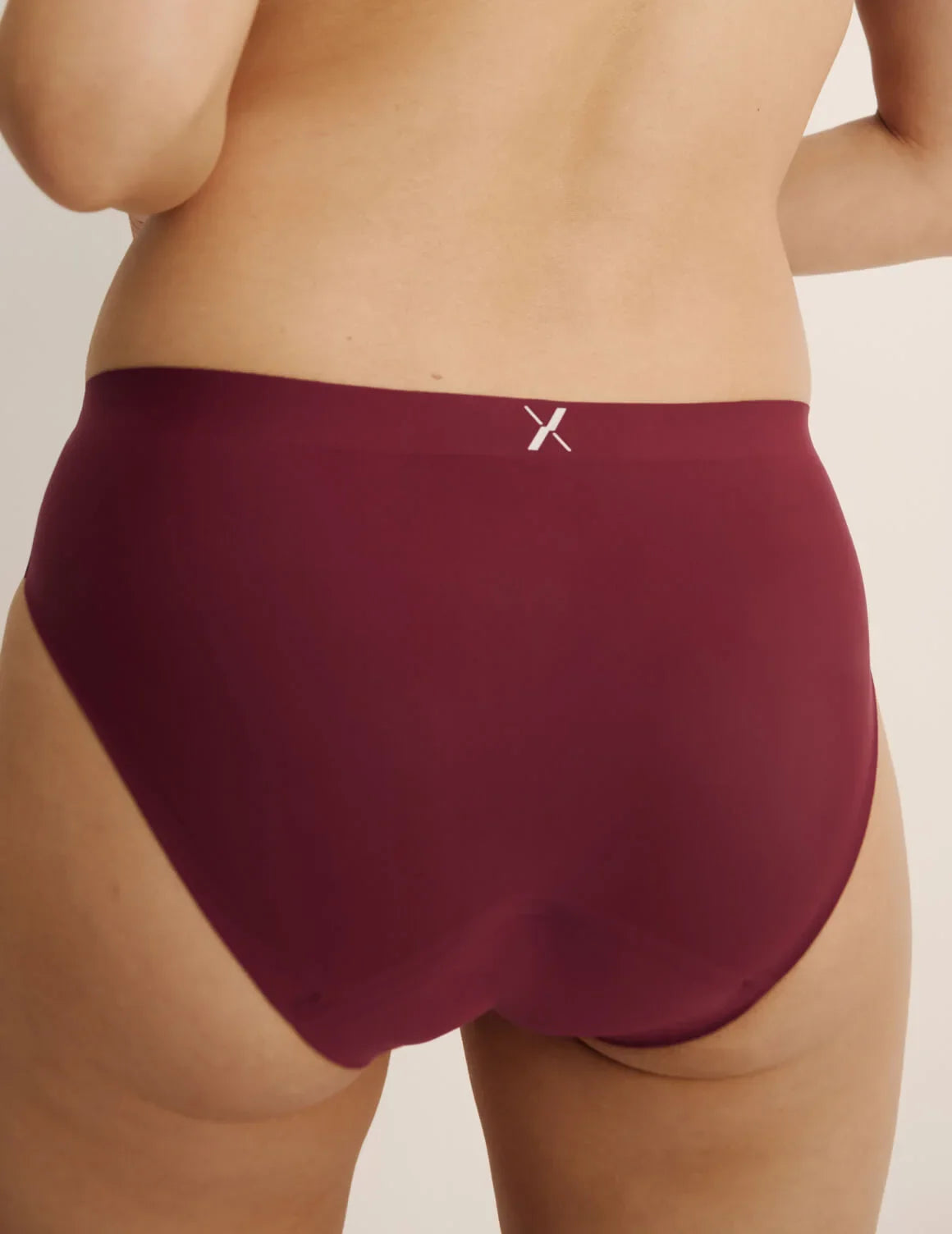 Back view of model wearing the Super Leakproof® No-Show Bikini highlighting the coverage and smooth fit – Dark Cherry – view 12 of 29
