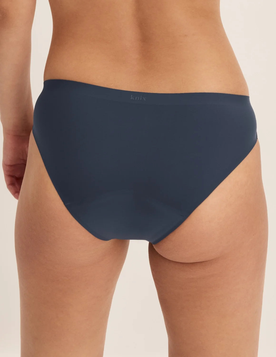 Back view of model wearing the Super Leakproof® No-Show Bikini highlighting the coverage and smooth fit – Twilight Navy – view 6 of 29