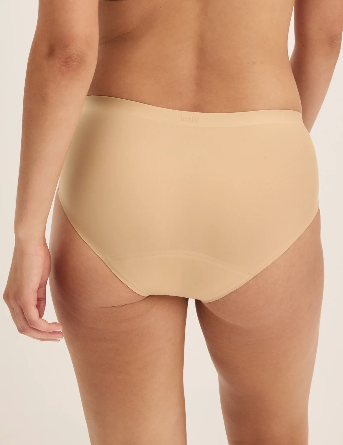 Back view of model wearing the Super Leakproof® No-Show Boyshort highlighting the coverage and smooth fit – Warm Sand – view 9 of 28