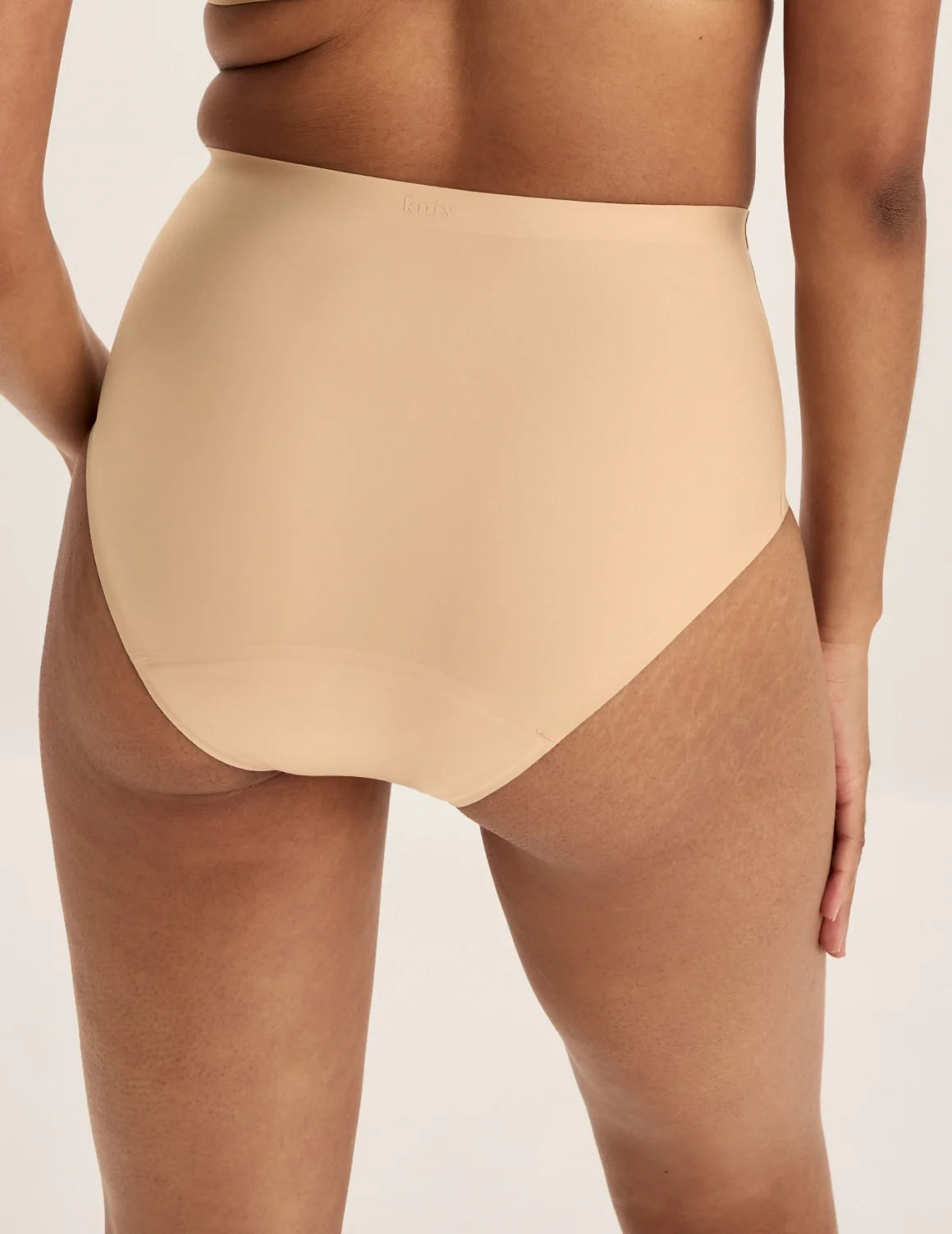 Back view of model wearing the Super Leakproof® No-Show High Rise highlighting the coverage and smooth fit – Warm Sand – view 9 of 27