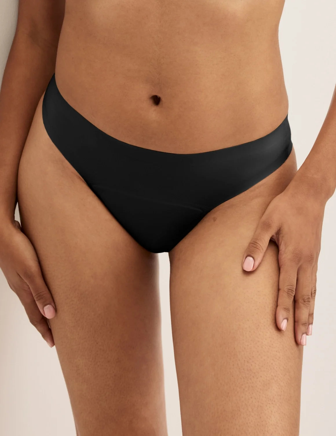 Front view of model wearing the Super Leakproof® No-Show Thong highlighting the coverage and smooth fit – Black – view 1 of 28
