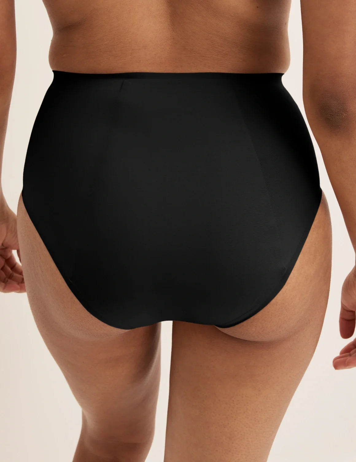 Back view of model wearing the SuperPlus Leakproof® No-Show High Rise highlighting the coverage and smooth fit – Black – view 3 of 21