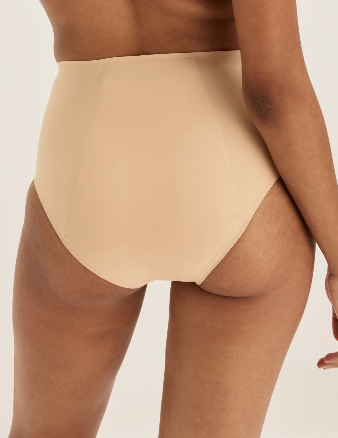 Back view of model wearing the SuperPlus Leakproof® No-Show High Rise highlighting the coverage and smooth fit – Warm Sand – view 12 of 21