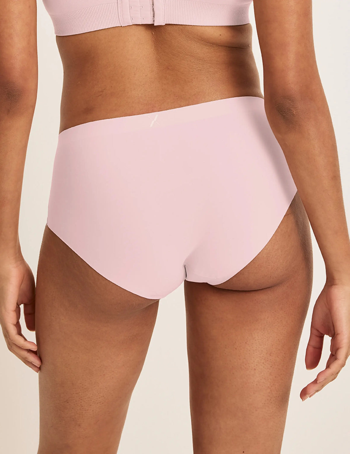 Back view of model wearing the Light Leakproof No-Show Boyshort highlighting the coverage and smooth fit – Rose Water – view 9 of 17