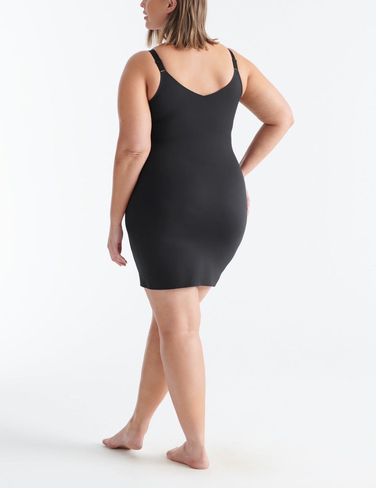 Back view of model wearing the LuxeLift Slip highlighting the neckline, strap design and fit – Black – view 7 of 15