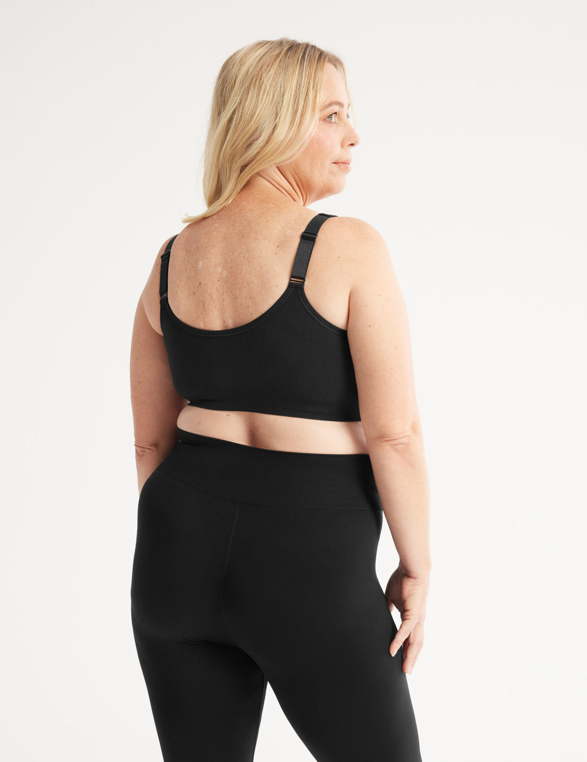 Back view of model wearing the Ultra Soft Front Closure Bra, highlighting the neckline, easy front closure, and seamless knit silhouette – Black – view 7 of 13