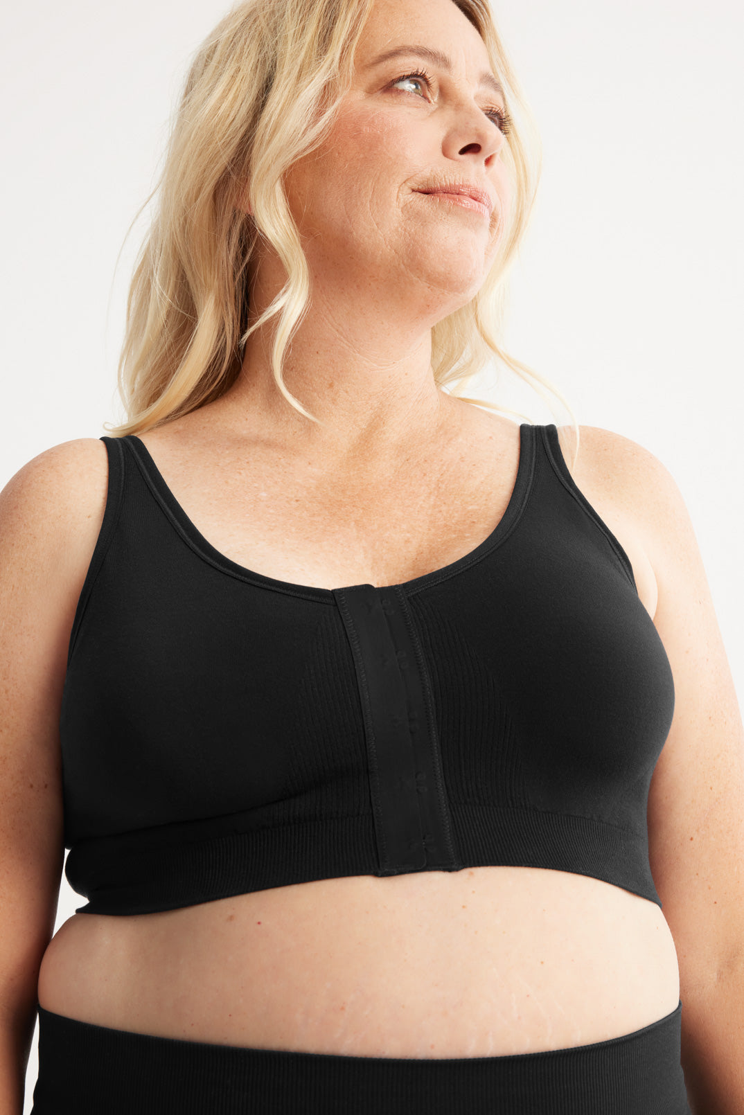 Front view of model wearing the Ultra Soft Front Closure Bra, highlighting the neckline, easy front closure, and seamless knit silhouette – Black – view 1 of 13