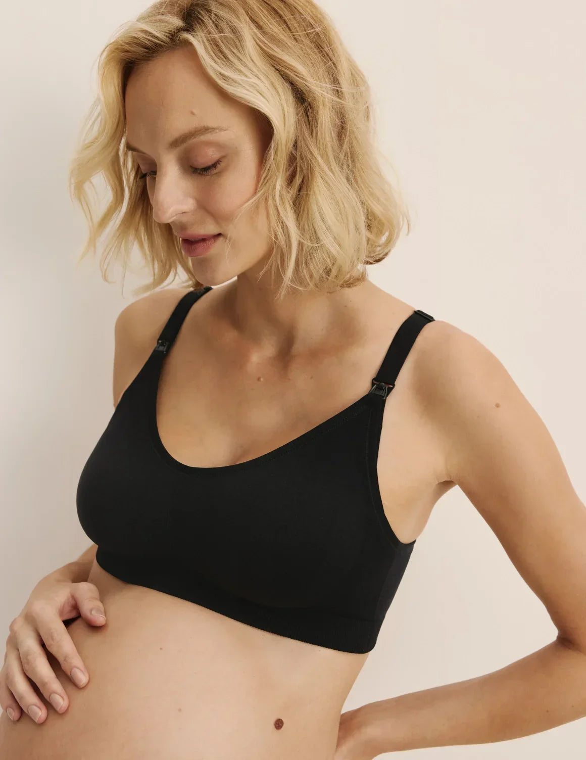Front view of model wearing the BlissFit™ Nursing Bra, highlighting the neckline, nursing clip strap design, and smooth silhouette – Black – view 9 of 15