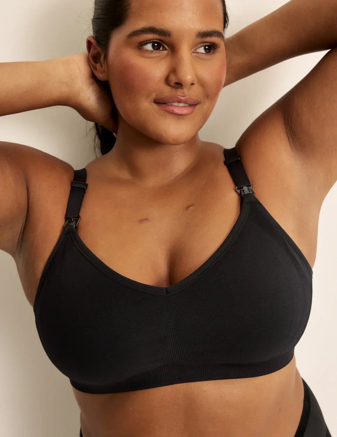 Front view of model wearing the BlissFit™ Nursing/Pumping Bra, highlighting the neckline, nursing clip strap design, and smooth silhouette – Black – view 2 of 13