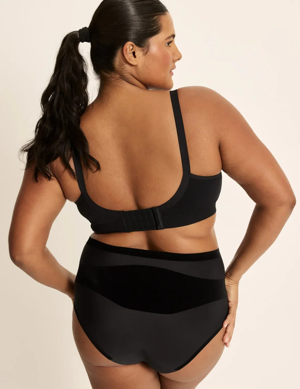 Back view of model wearing the BlissFit™ Nursing/Pumping Bra, highlighting the neckline, nursing clip strap design, and smooth silhouette – Black – view 5 of 13