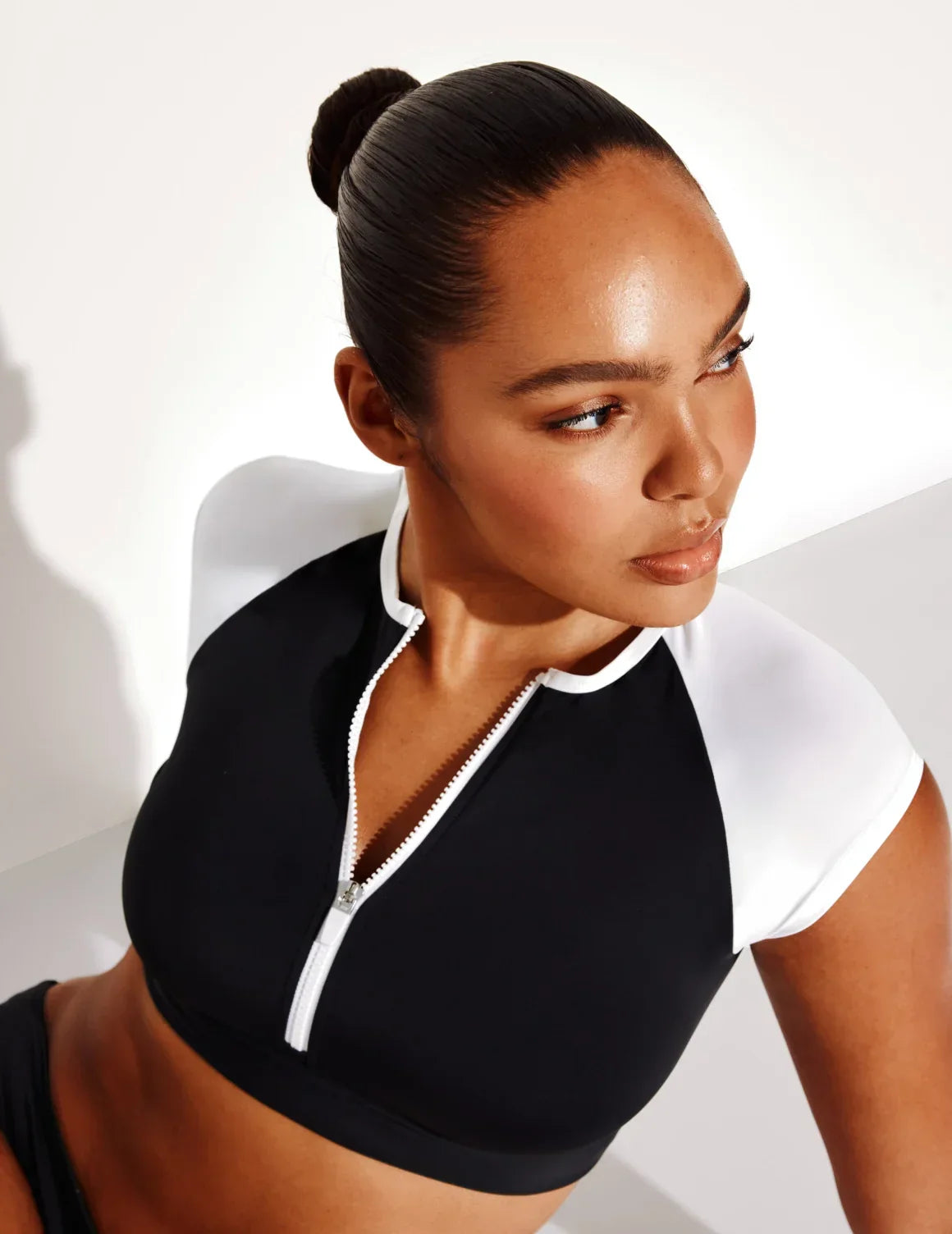 Front view of model wearing the Cap-Sleeve Bikini Top, highlighting the neckline, strap design, and smooth silhouette – Black/White – view 4 of 5