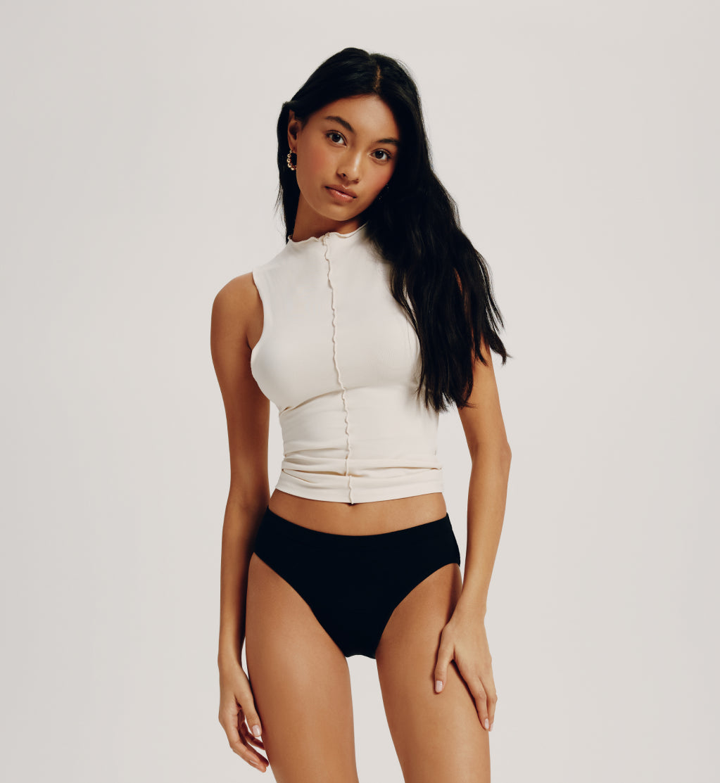 Front view of model wearing the Teen Leakproof Cotton Bikini highlighting the coverage and fit – Black – view 1 of 11