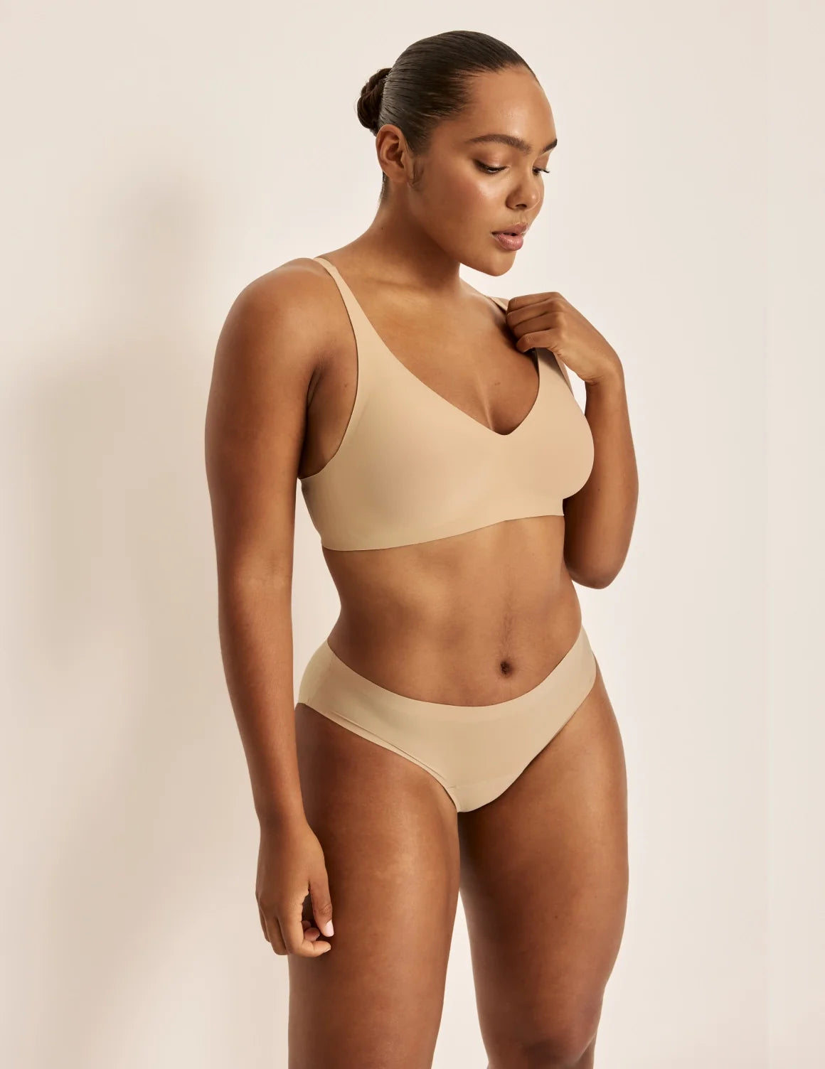 Full-body view of model wearing the Essential No-Show Bikini highlighting the coverage and smooth fit – Nude Multi – view 9 of 18