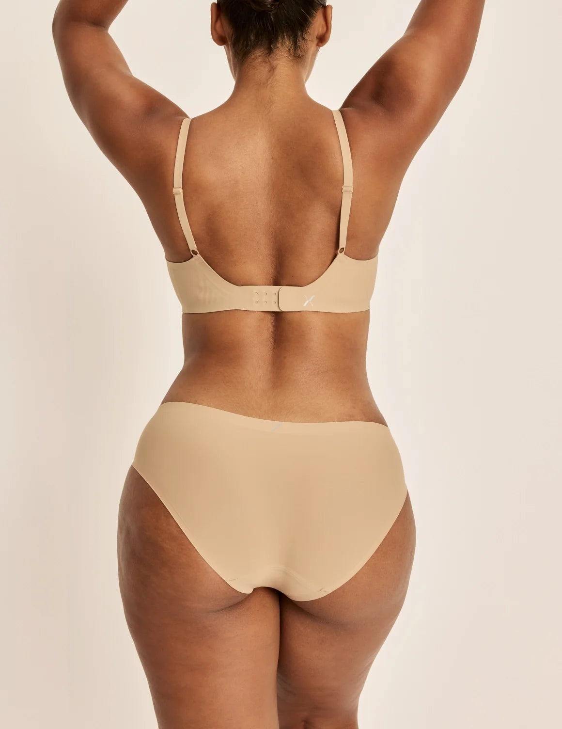 Back view of model wearing the Essential No-Show Bikini highlighting the coverage and smooth fit – Nude Multi – view 10 of 18