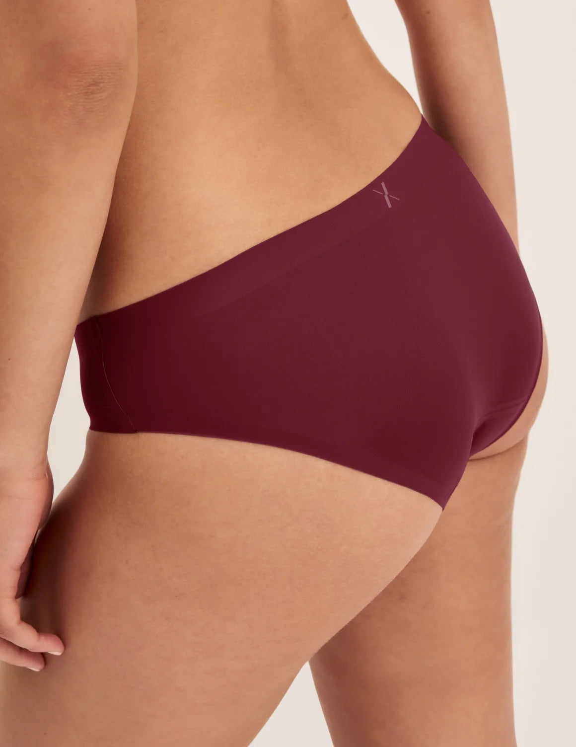 Back view of model wearing the Essential No-Show Bikini highlighting the coverage and smooth fit – Pink Multi – view 5 of 18