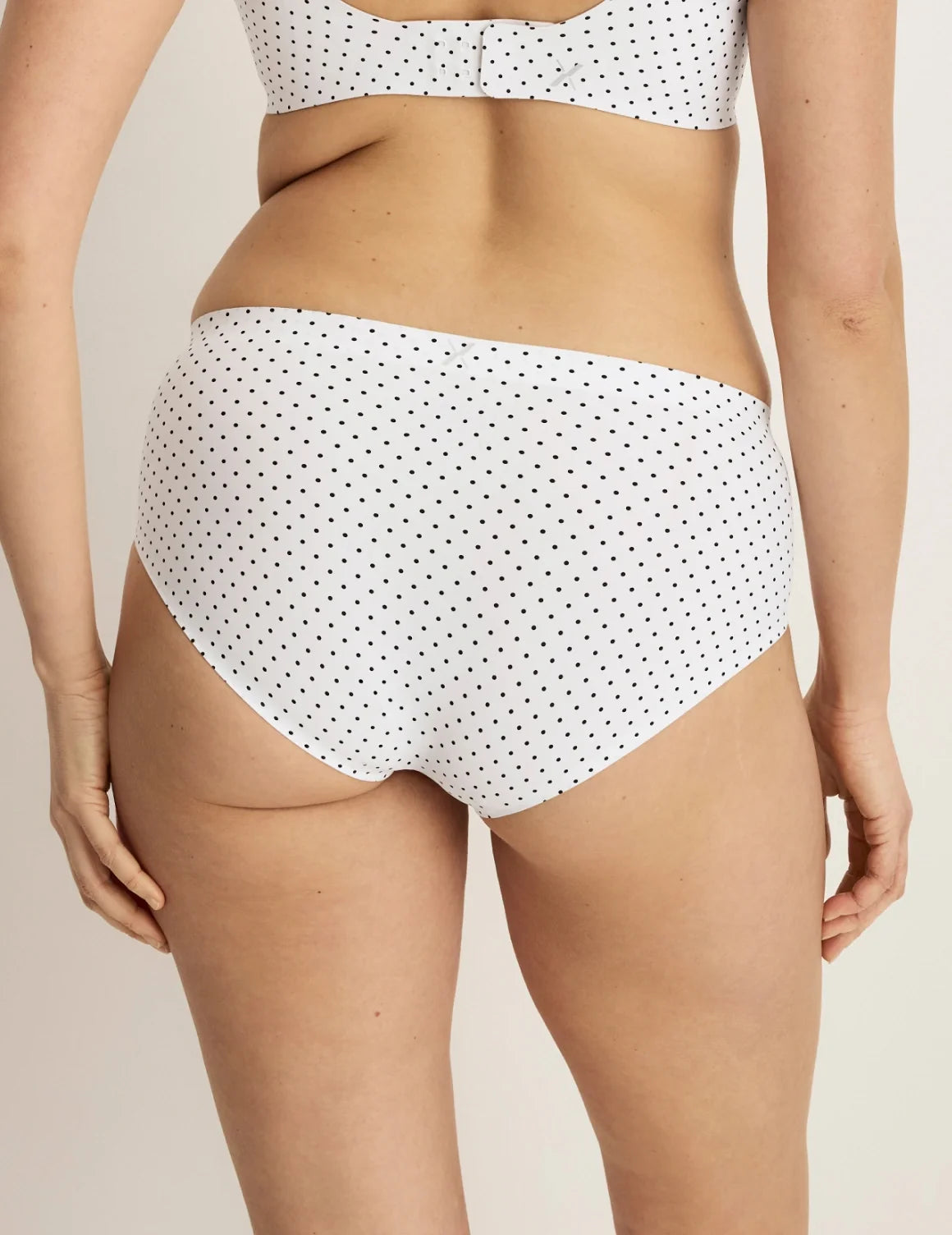Back view of model wearing the Essential No-Show Boyshort highlighting the coverage and smooth fit – White with Black Polka Dot – view 3 of 27