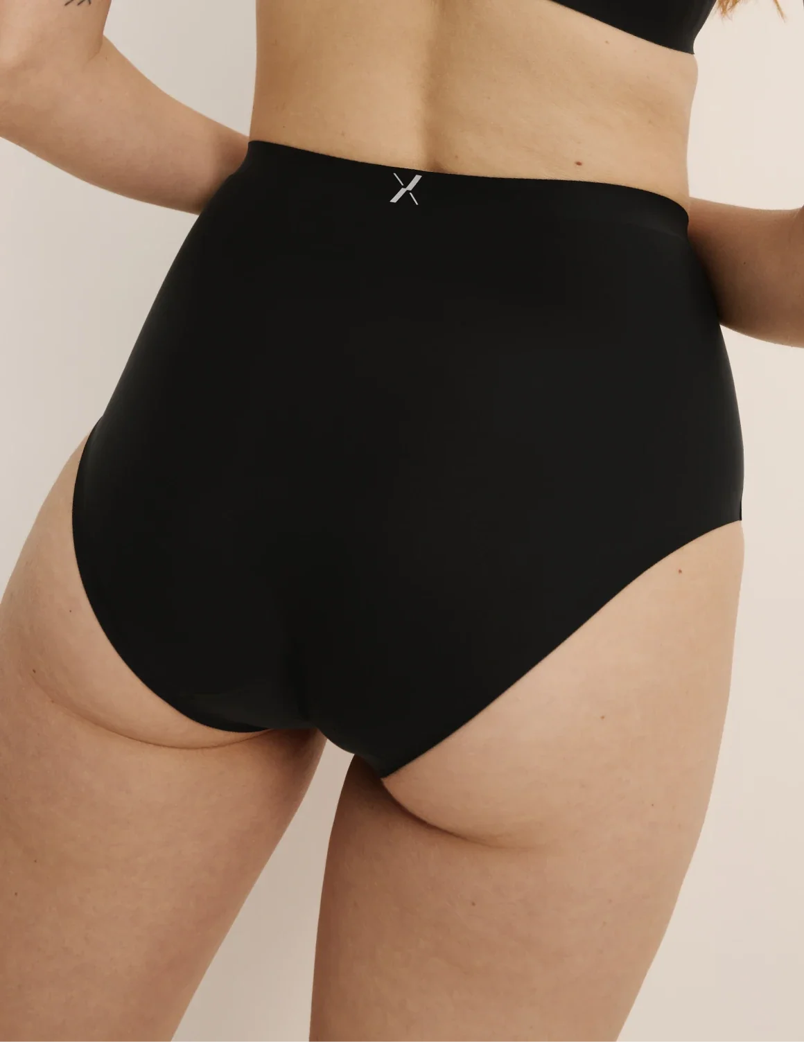 Back view of model wearing the Essential No-Show High Rise highlighting the coverage and smooth fit – Black – view 11 of 32