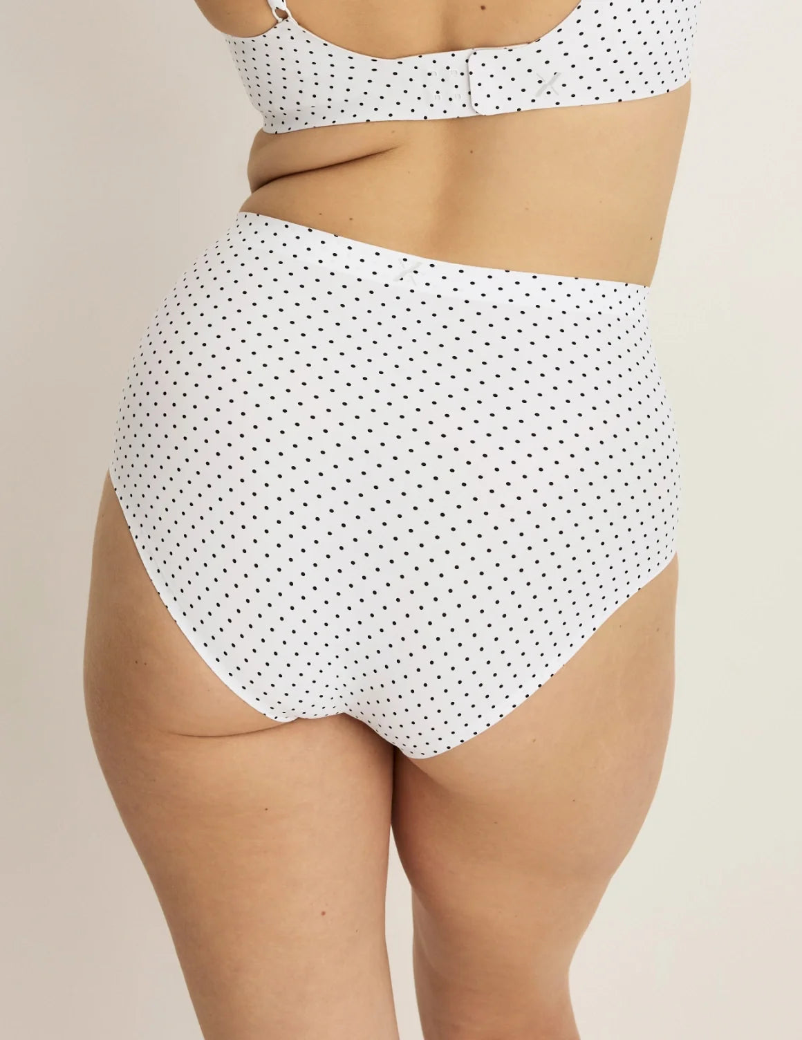 Back view of model wearing the Essential No-Show High Rise highlighting the coverage and smooth fit – White with Black Polka Dot – view 7 of 32