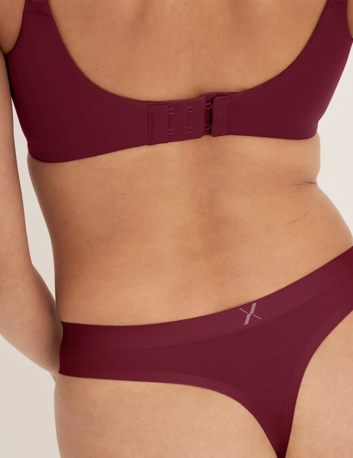 Back view of model wearing the Essential No-Show Thong highlighting the coverage and smooth fit – Pink Multi – view 11 of 18