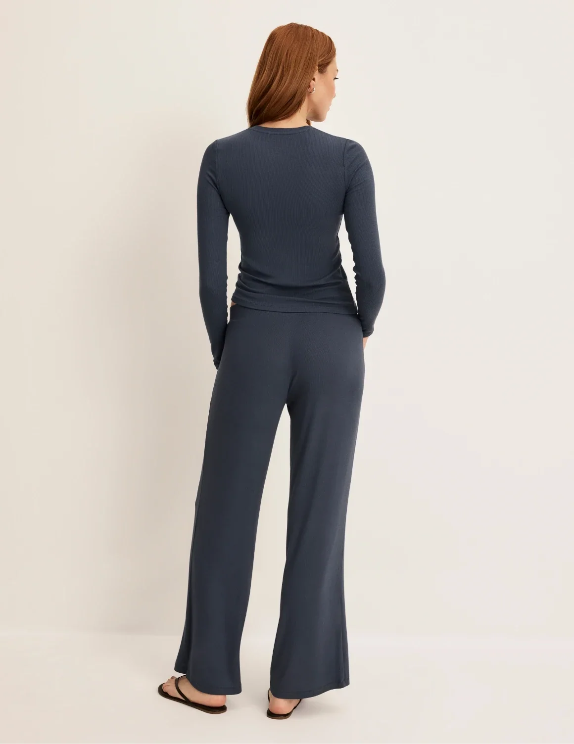 Back view of model wearing the Modal Rib Pant highlighting the coverage and fit – Twilight Navy – view 11 of 13