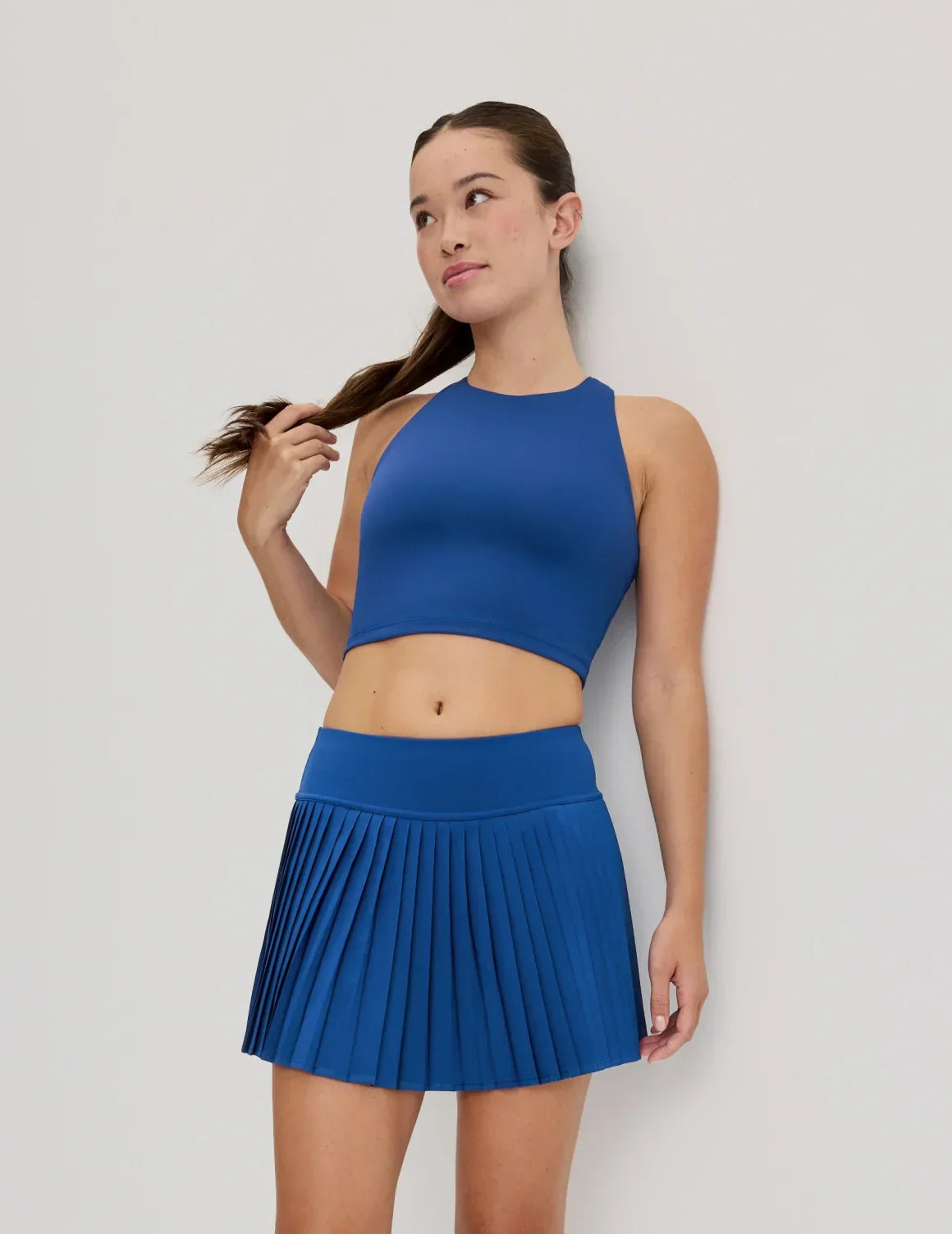 Front view of model wearing the Teen First Serve Racerback Tank highlighting the coverage and fit – Shady Blue – view 8 of 9