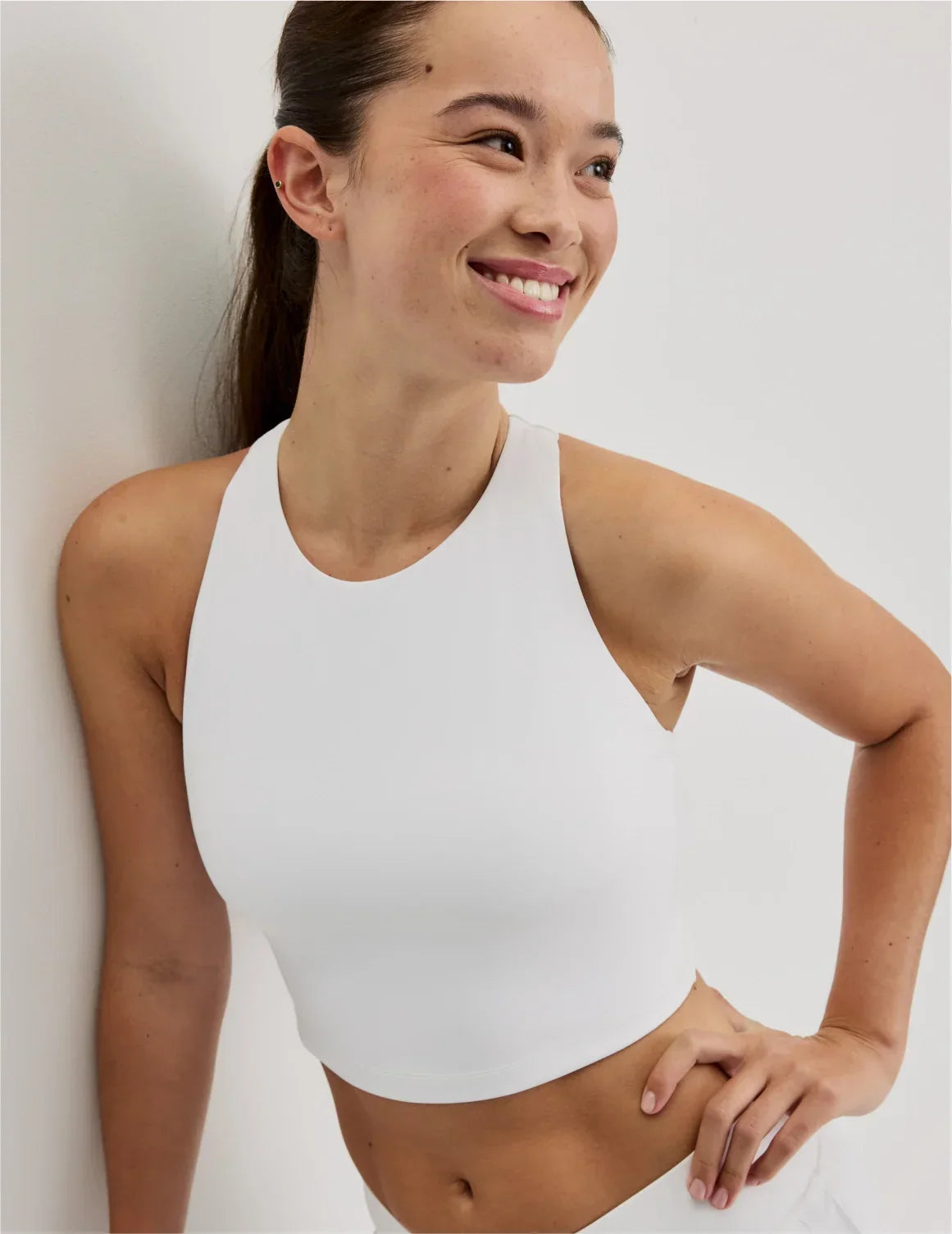 Front view of model wearing the Teen First Serve Racerback Tank highlighting the coverage and fit – White – view 3 of 9