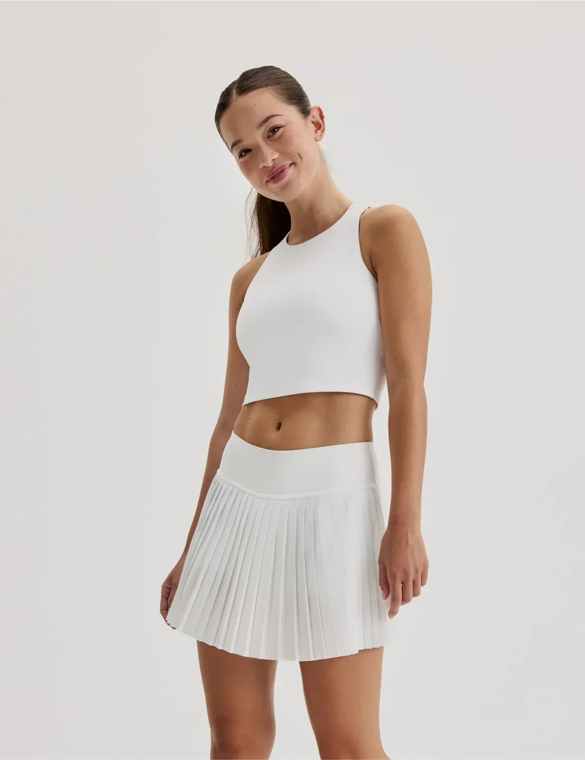 Front view of model wearing the Teen First Serve Racerback Tank highlighting the coverage and fit – White – view 9 of 9