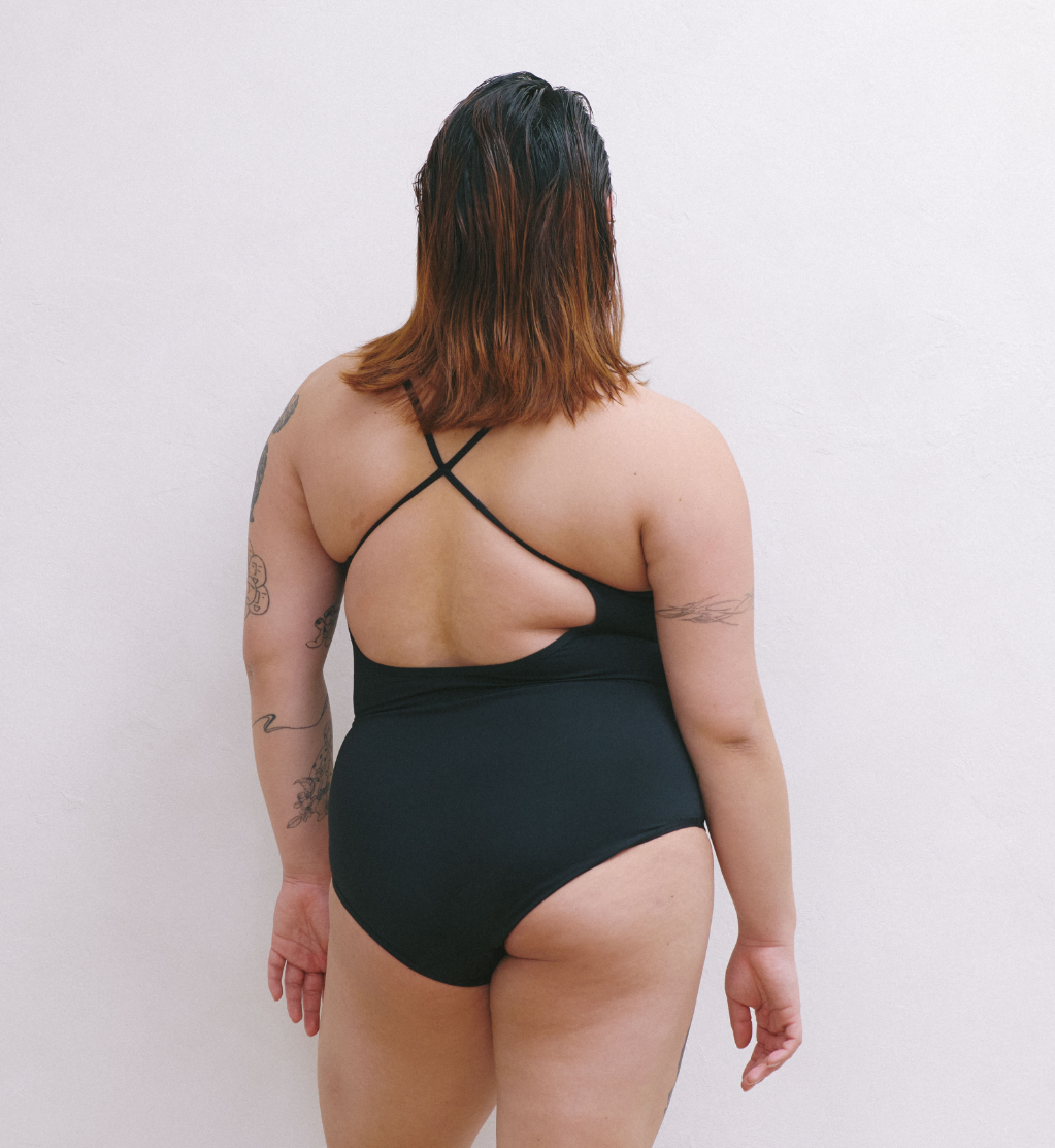 Back view of model wearing the Teen Period Swim Freestyle One-Piece highlighting the coverage and fit – Black – view 8 of 37