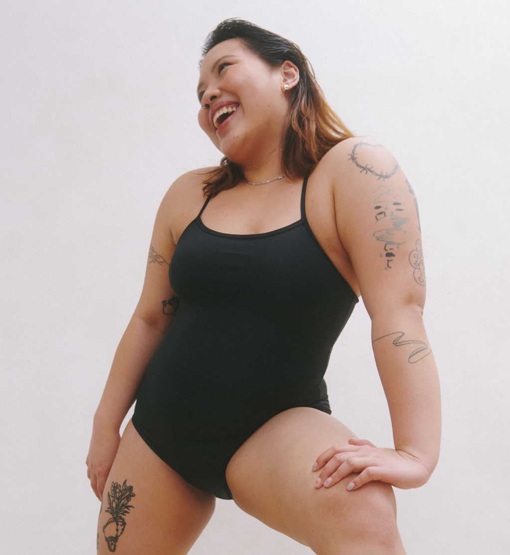 Front view of model wearing the Teen Period Swim Freestyle One-Piece highlighting the coverage and fit – Black – view 9 of 37