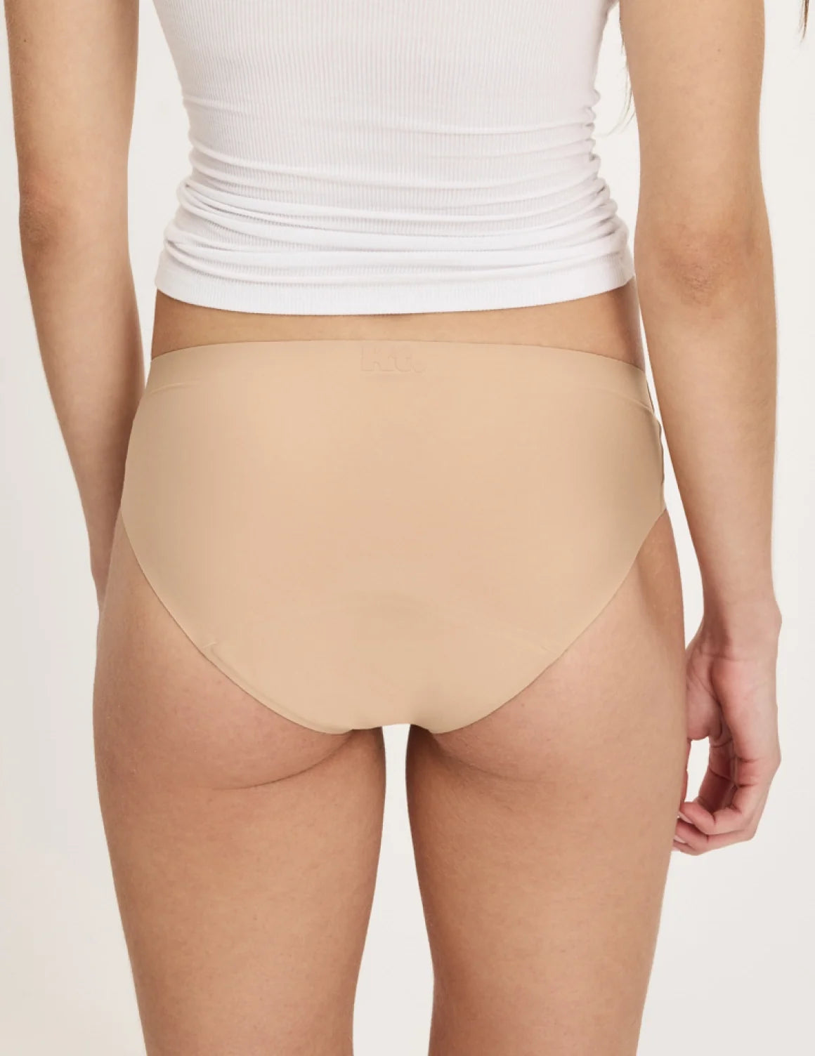 Back view of model wearing the Teen Super Leakproof® No-Show Bikini highlighting the coverage and smooth fit – Warm Sand – view 11 of 49