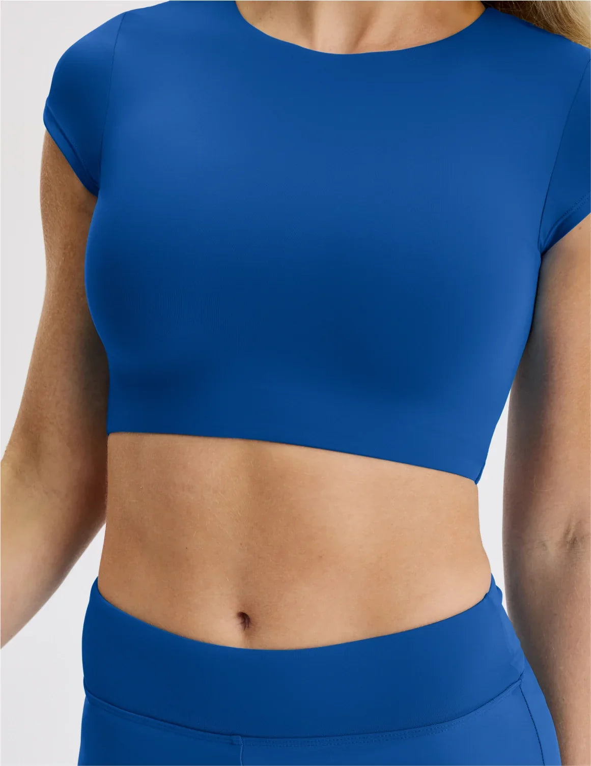 Front view of model wearing the Teen High Tide Cropped Swim Top highlighting the coverage and fit – Shady Blue – view 10 of 11