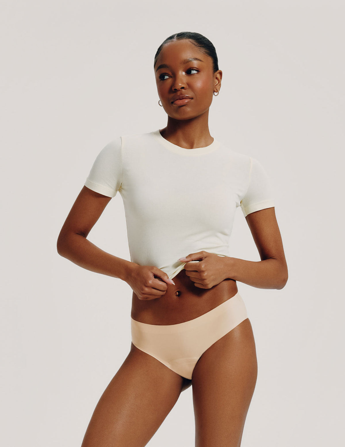 Front view of model wearing the Teen Leakproof UltraThin No-Show Bikini highlighting the coverage and smooth fit – Warm Sand – view 7 of 72