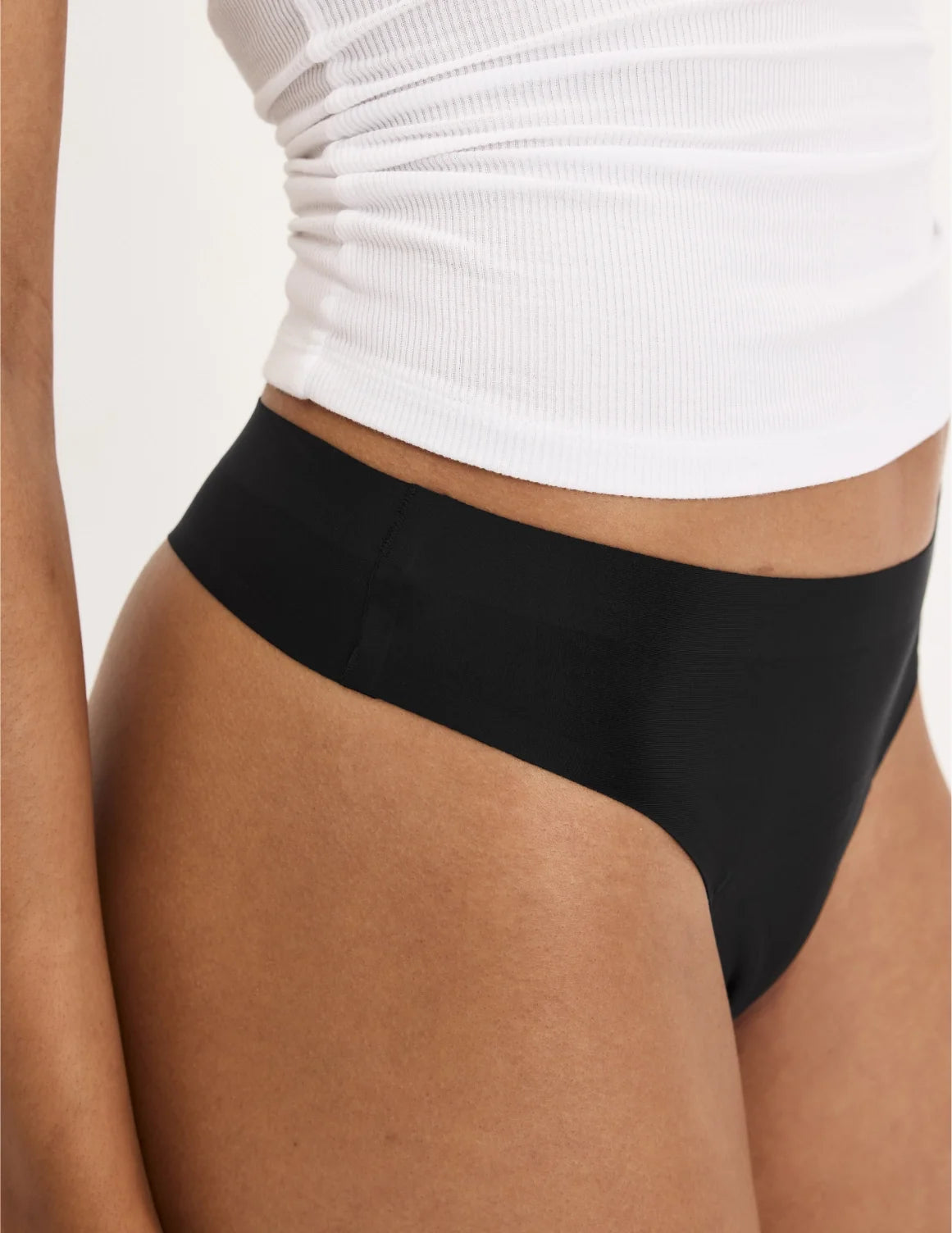 Front view of model wearing the Teen Leakproof UltraThin No-Show Thong highlighting the coverage and smooth fit – Black – view 9 of 34