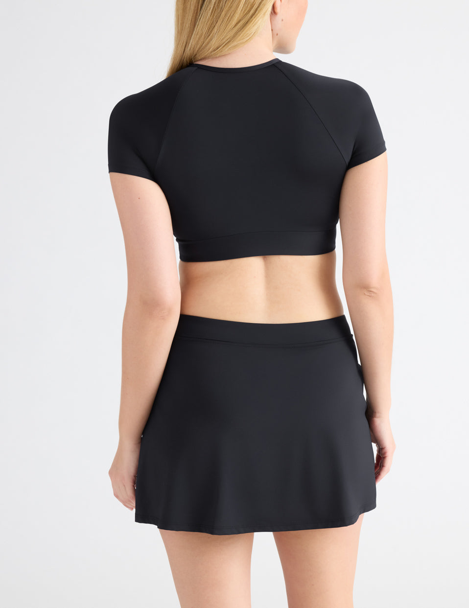 Back view of model wearing the Leakproof Swim Skirt highlighting the coverage and fit – Black – view 3 of 7