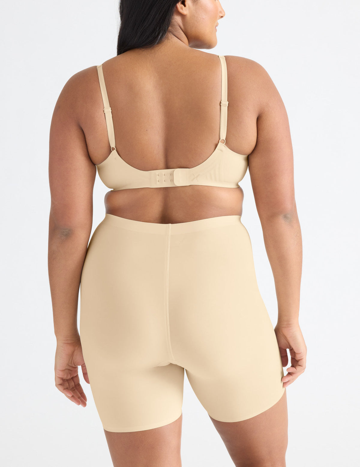Back view of model wearing the Leakproof Thigh Saver® 6” highlighting the coverage and smooth fit – Dune – view 8 of 32