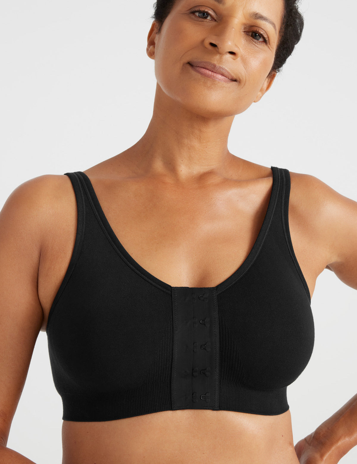 Front view of model wearing the Ultra Soft Front Closure Bra, highlighting the neckline, easy front closure, and seamless knit silhouette – Black – view 11 of 13