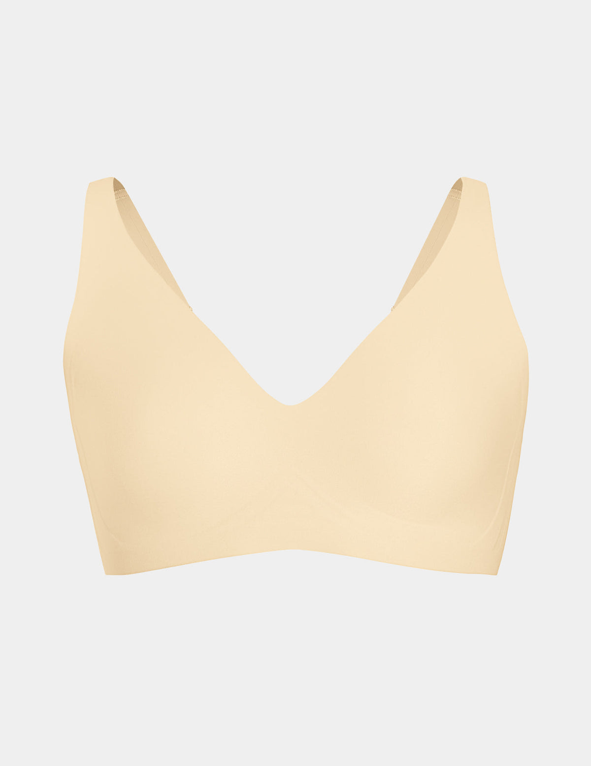 Wireless bra with a V-neckline, adjustable straps, and smooth molded cups, shown front-facing against a light gray background – Dune – view 10 of 50
