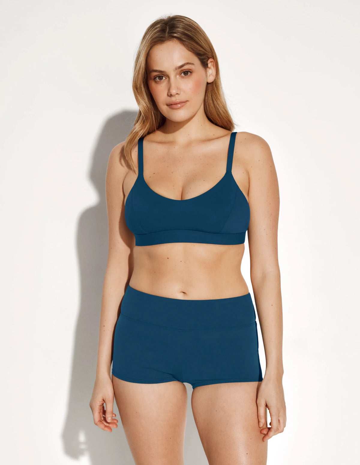 Full-body view of model wearing the Sculpt Scoop Bikini Top, highlighting the neckline, strap design, and silhouette – Horizon – view 4 of 8