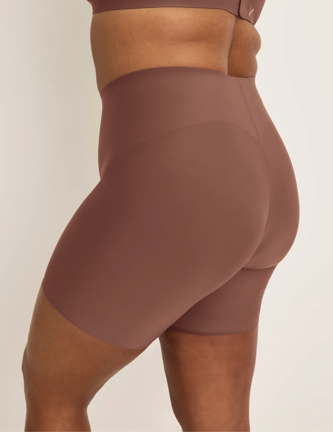 Side view of model wearing the Leakproof Contour Thigh Saver® 6”, highlighting the coverage and smooth fit – Sola – view 9 of 19