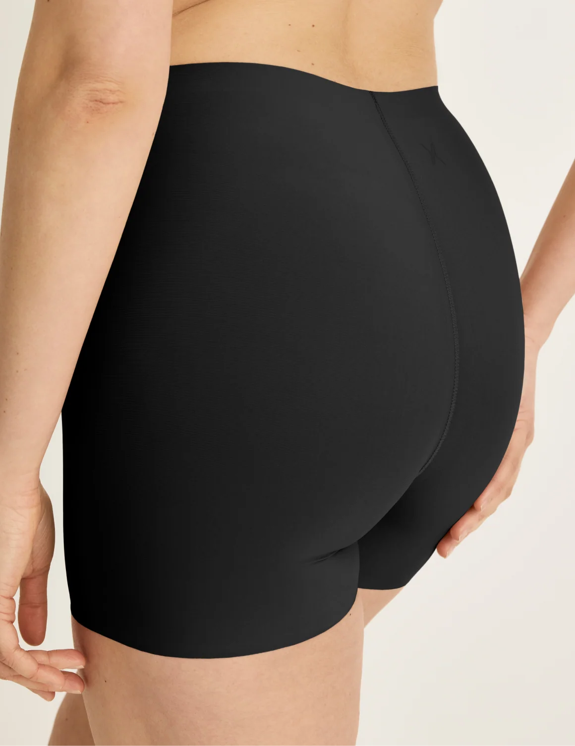 Back view of model wearing the Shortie Thigh Saver® 4”, highlighting the coverage and smooth fit – Black – view 3 of 25