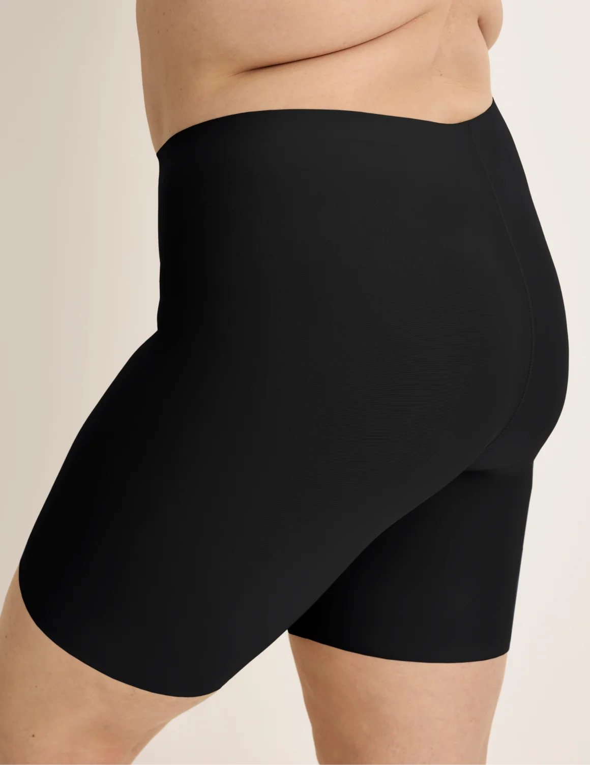 Side view of model wearing the Thigh Saver® 6” highlighting the coverage and smooth fit – Black – view 3 of 33