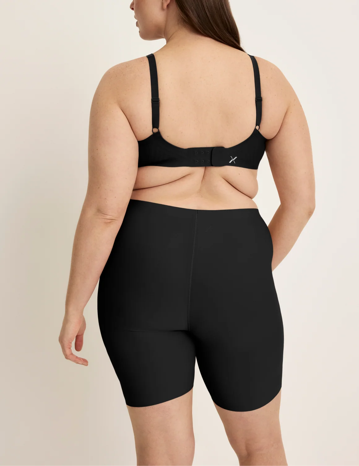 Back view of model wearing the Thigh Saver® 6” highlighting the coverage and smooth fit – Black – view 4 of 33