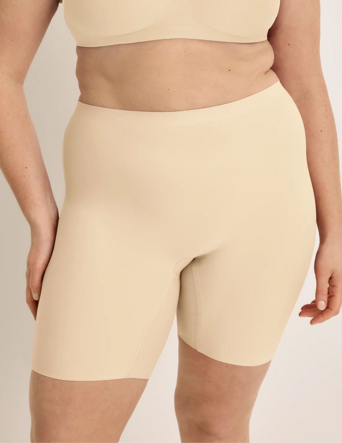 Front view of model wearing the Thigh Saver® 6” highlighting the coverage and smooth fit – Dune – view 6 of 33