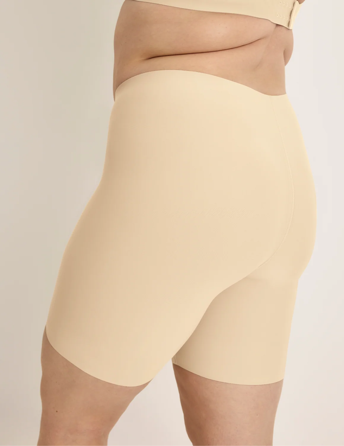 Side view of model wearing the Thigh Saver® 6” highlighting the coverage and smooth fit – Dune – view 8 of 33
