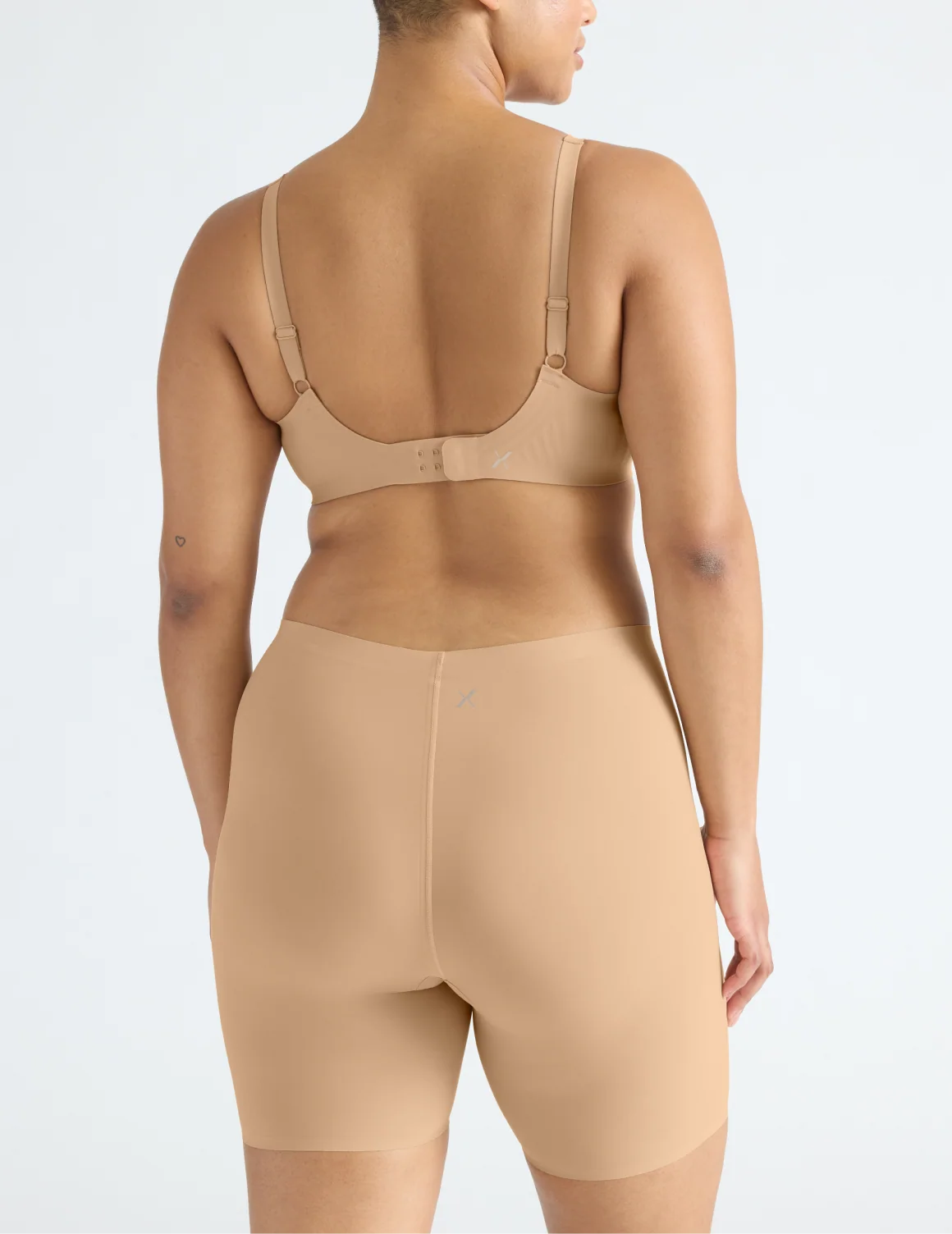 Back view of model wearing the Leakproof Thigh Saver® 6” highlighting the coverage and smooth fit – Warm Sand – view 12 of 32