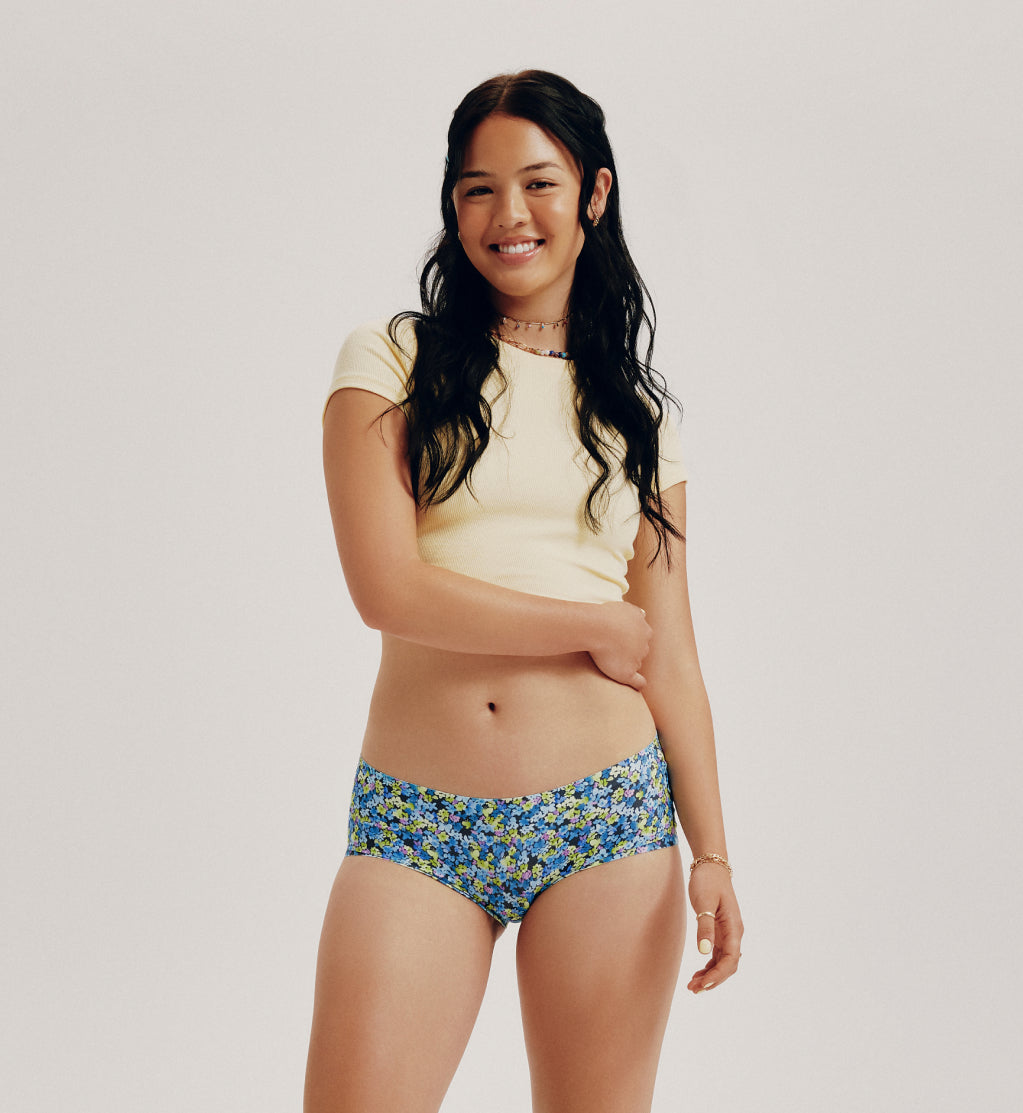 Front view of model wearing the Teen Light Leakproof No-Show Boyshort highlighting the coverage and smooth fit – Electric Petals – view 1 of 93