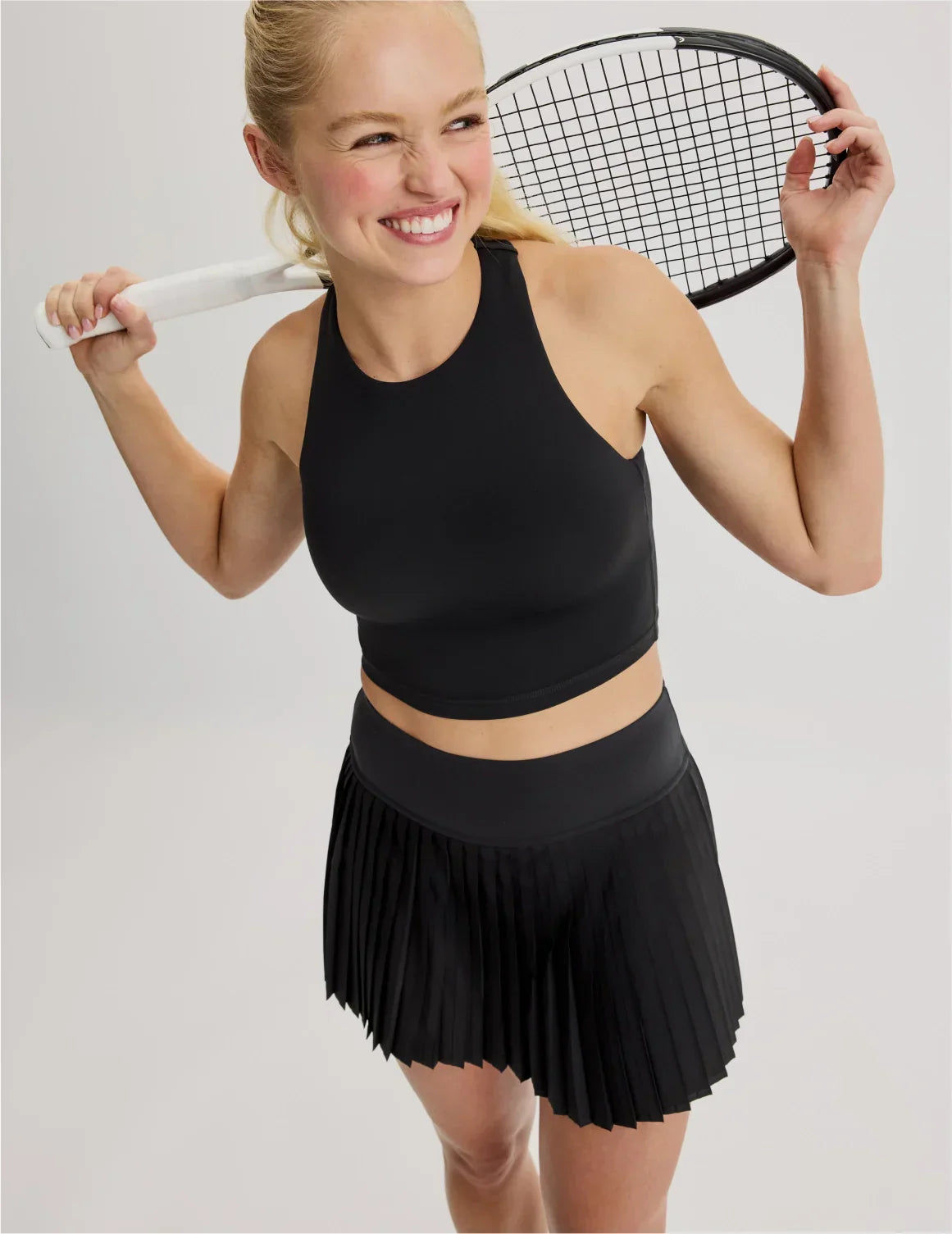 Front view of model wearing the Teen First Serve Pleated Skort highlighting the coverage and fit – Black – view 10 of 11
