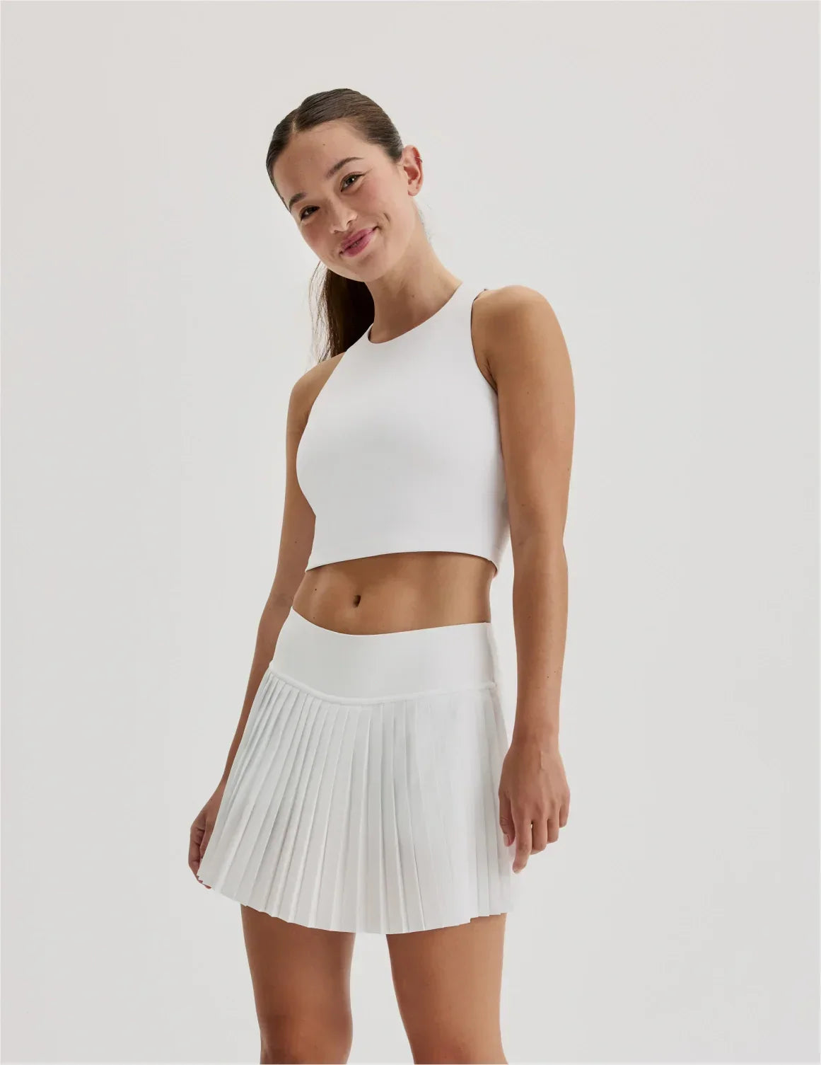 Front view of model wearing the Teen First Serve Pleated Skort highlighting the coverage and fit – White – view 3 of 11