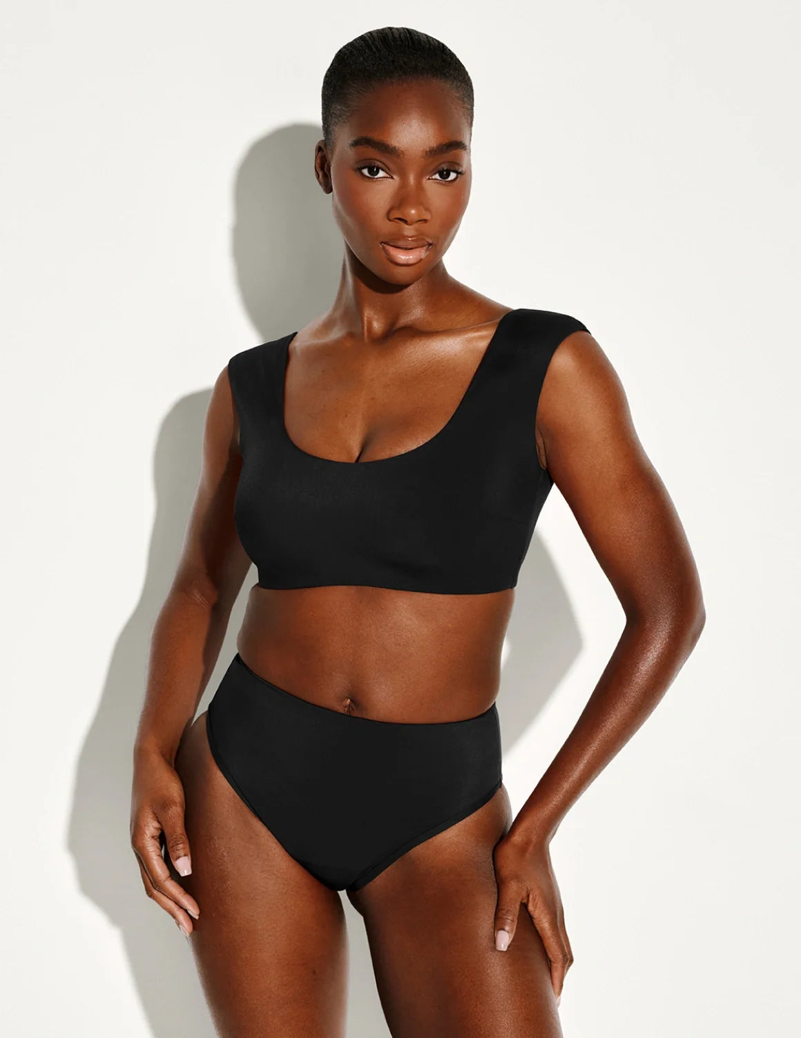 Front view of model wearing the Leakproof Sculpt High Rise Bikini Swim Bottom highlighting the coverage and fit – Black – view 1 of 21